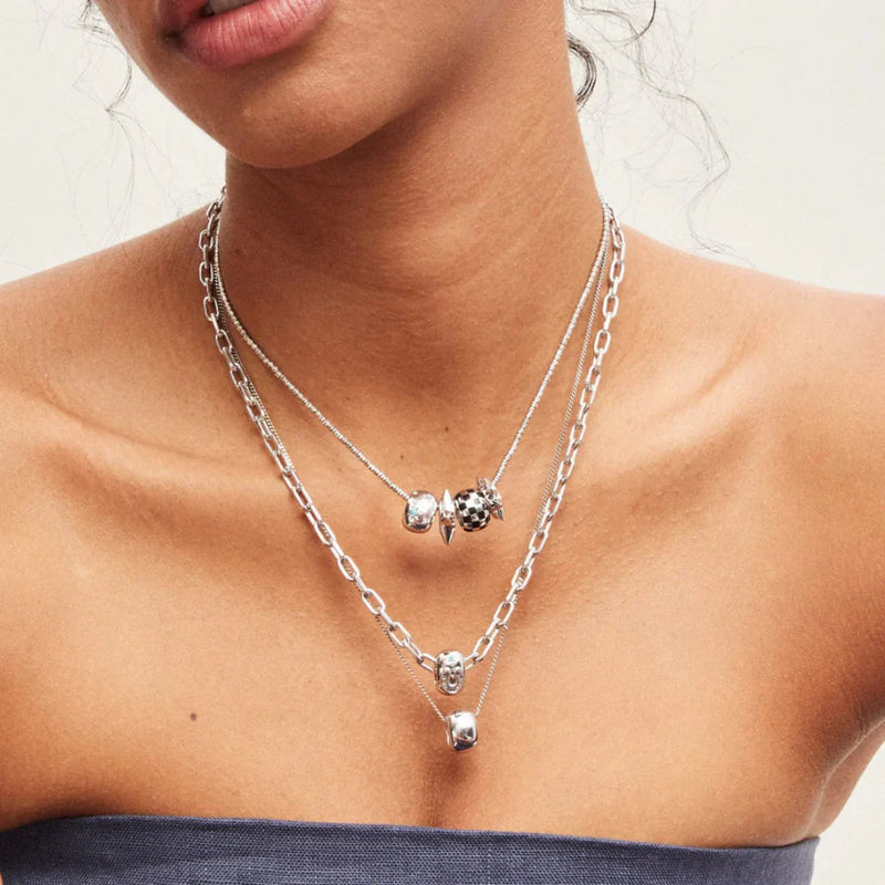 Model wearing Adina Reyter’s layered necklace, available at LADDER.