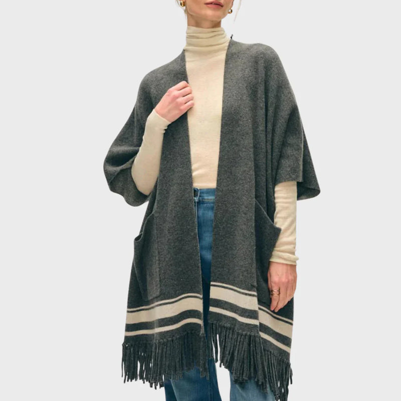 Model wearing LADDER’s cashmere-blend fringe poncho, by White & Warren.