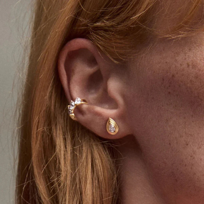 Woman wearing pear diamond studs from LADDER, designed by Adina Reyter.