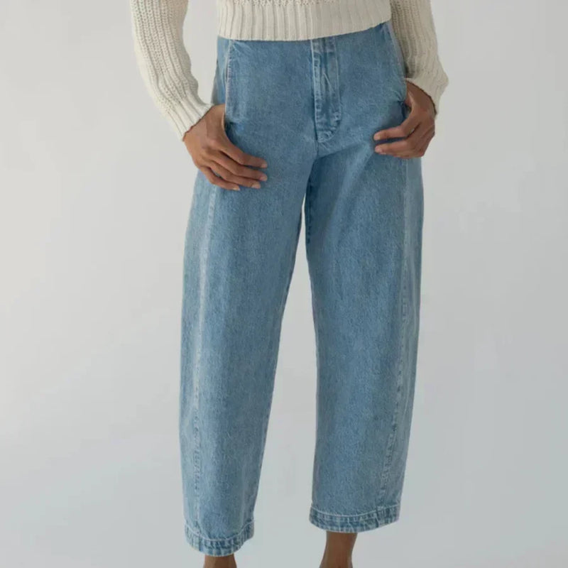 Woman wearing a pair of blue jeans from LADDER, designed by Shaina Mote.