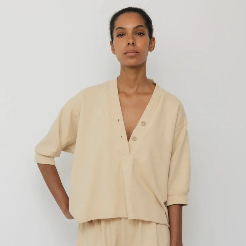 A woman wearing a Short Sleeve Sweatshirt designed by Wol Hide.